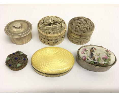 A continental silver and yellow guilloche enamel pill box with other examples including bone