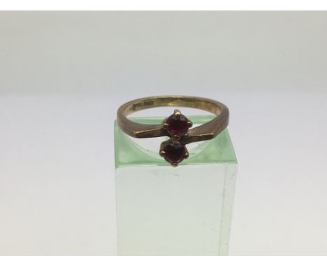 A 9ct gold set with two red stones, approx 2.5g and approx size M.