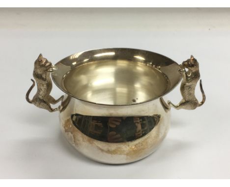 A two handled silver bowl, the handles in the form of cats, approx height 6cm, London hallmarks.