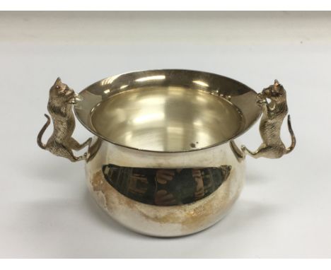 A two handled silver bowl, the handles in the form of cats, approx height 6cm, London hallmarks.