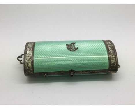 A silver and enamel compact.