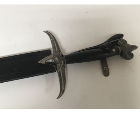 An ornamental blunt edged modern sword decorated with rams heads with leather scabbard - NO RESERVE