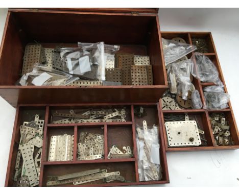 A wooden fitted box containing 3 layers of pre war silver Meccano, including pulleys, Motor, Nuts and bolts, plates etc - NO 