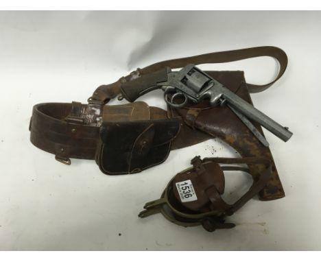 A 1940s Thomlison Ltd Sam Brown belt, brass spurs and vintage cap gun.