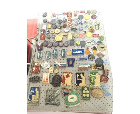 A collection of interesting vintage badges including Russian political badges and other world badges.