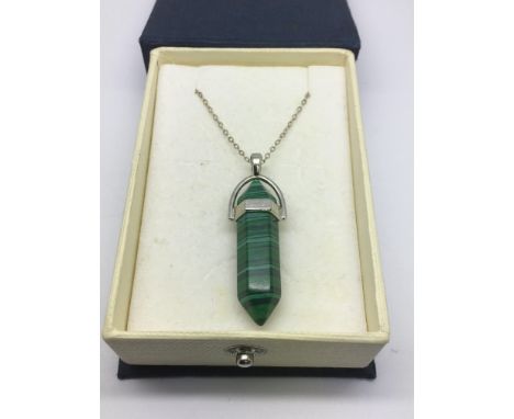 A malachite pendant on a silver chain.