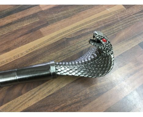 A walking stick with cobra handle