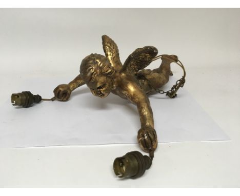 A gilded composition hanging light in the form of a winged cherub.
