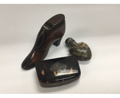 A 19th century Mahogany snuff box in the form of a shoe dated 1876 with brass stud decoration a heart shaped silver and snake