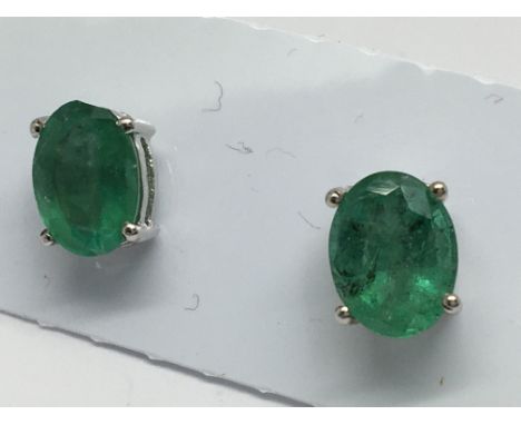 A pair of emerald studs in silver