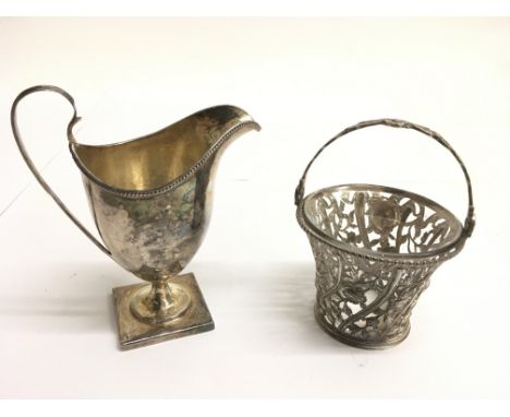 A Georgian silver helmet shaped jug and a pierced silver bucket