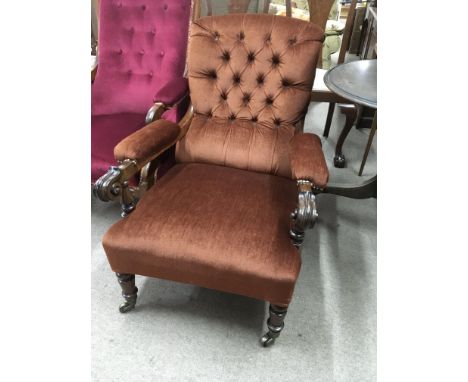 A Victorian open arm chair with brown button back on turned legs - NO RESERVE