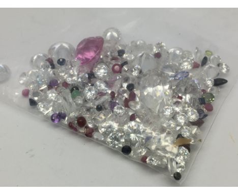 A bag of loose mixed stones including cubic zirconia, ruby, sapphire, opal and emerald 105.20ct