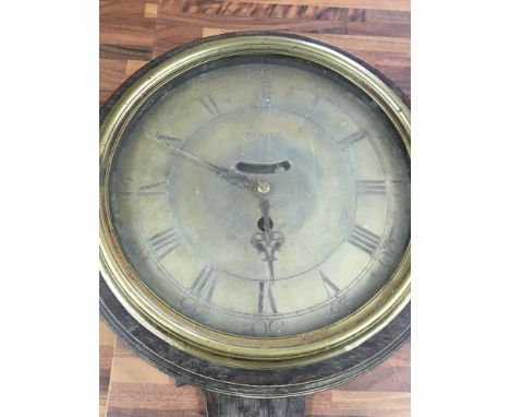 A 19th century oak case circular wall clock with verge movement.The brass dial with Roman numerals inscribed Moore .dial 22.5
