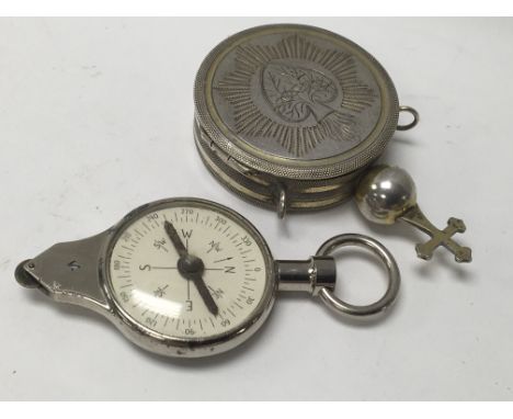 A WWII compass and map mileage calculator together with a silver pill box