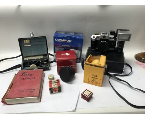 A small collection of cameras and accessories, alongside a Leica manual. Includes Kodak safelight lamps - NO RESERVE