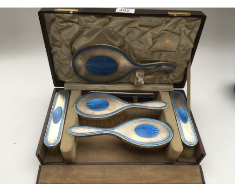 A cased hallmarked silver and guilloche enamel brush set by Goldsmiths &amp; silversmiths co. LONDON