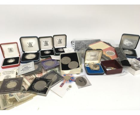 A collection of mint silver proof commemorative coins used bank notes and other coins.