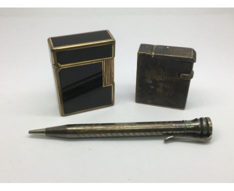 Two vintage lighters and a silver pencil.