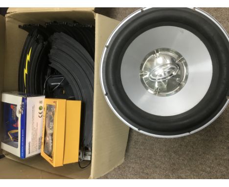 A box of Aurora track, die cast vehicles and a speaker.