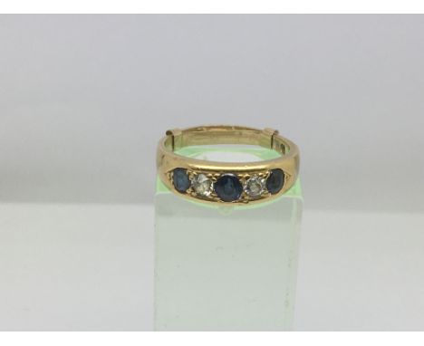 An 18ct gold ring set with alternating sapphires and diamonds, approx 4.2g and approx size M.