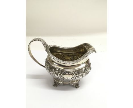 A Georgian, London silver cream jug, repousse decorated with foliage.Approx 223g