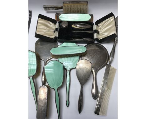 A collection of silver and enamel brushes and mirrors