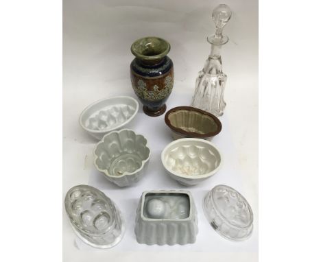 A Doulton Lambeth vase, group of ceramic jelly moulds and a glass bell decanter