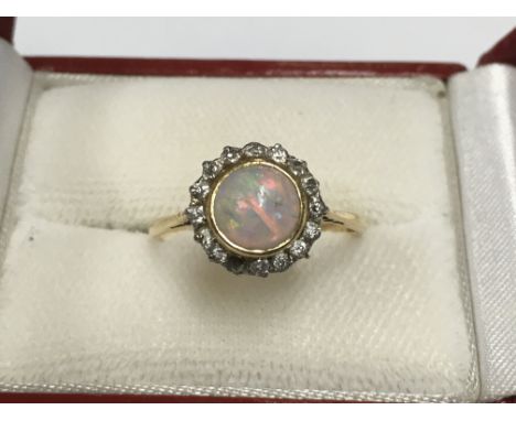 An 18ct gold untrusted opal and diamond ring (1 stone missing).