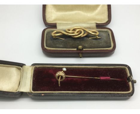 A 9ct gold brooch of celtic style plus a 15ct gold stick pin set with pearls.