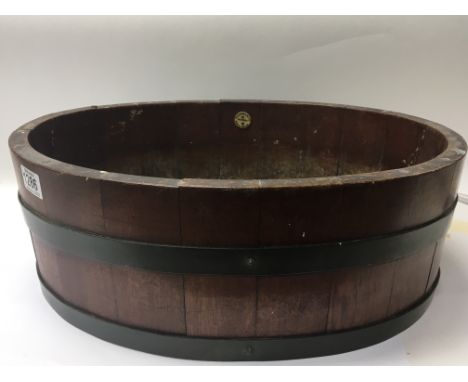 A mahogany and brass bound oval plant trough with applied makers name. 50cm diameter - NO RESERVE