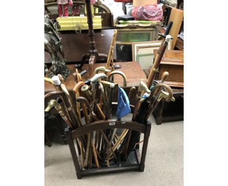 An oak stick stand and a collection of walking sticks.