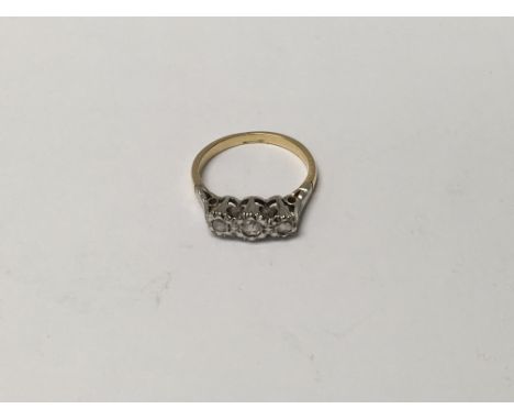 A unmarked gold ring inset with a row of three diamonds