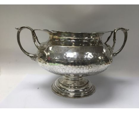 A arts and crafts style silver bowl with stylised twin handles London hallmarks 1904 1.164 kg 16 cm heigh.