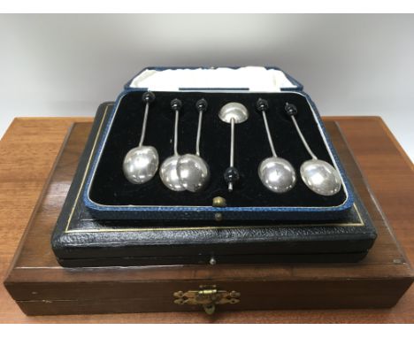 A cased set of Silver coffee spoons And cased flat ware .