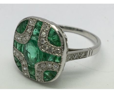 A platinum Art Deco- style emerald and diamond panel ring
