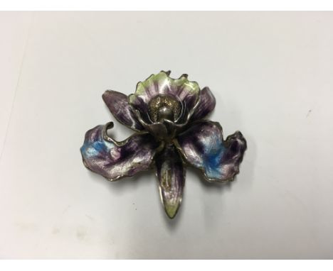 A silver and enamel orchid brooch.