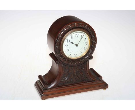 Carved mahogany balloon mantel clock with enamelled dial