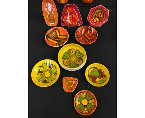 A selection of orange and yellow painted Poole pottery to include small bowls and a selection of plates.