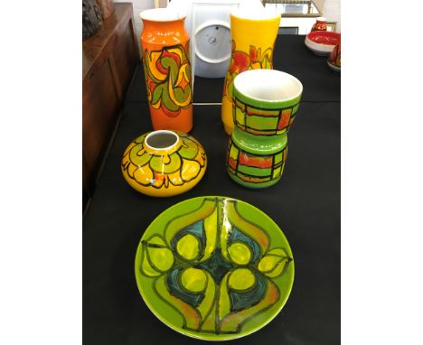 A selection of Poole pottery to include a green and blue decorated plate, five pieces in total.