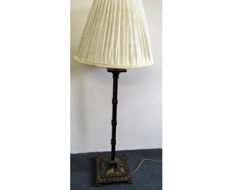 A black and gold painted standard lamp with Japanese scenes and cream shade.