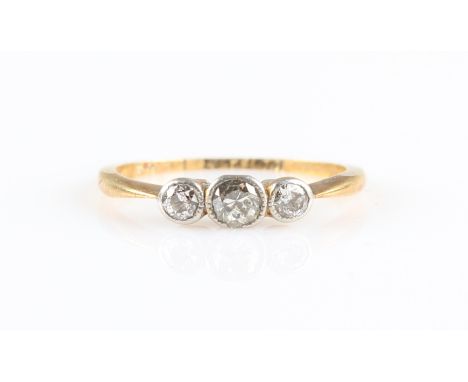 A three stone diamond ring, set with three graduated round brilliant cut diamonds, total diamond weight approx. 0.25ct, stamp