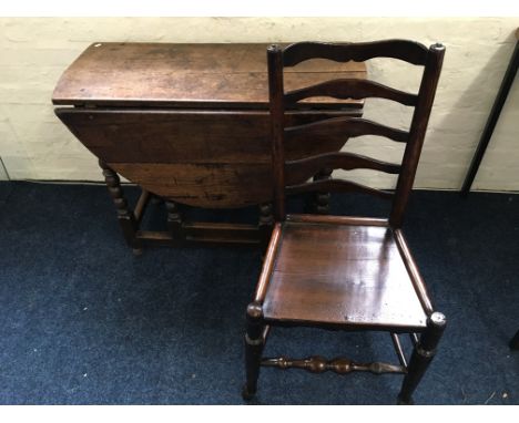 A 19th Century oak gate legged table with bobbin turner legs, together with a pair of 19th Century ladder back chairs