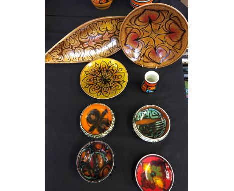 A selection of Poole pottery to include a shield shaped dish and a small vase. Eight pieces in total.