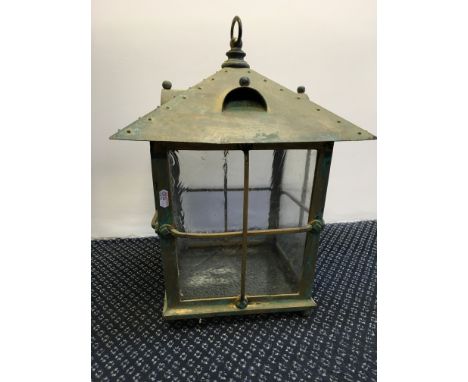 An Arts and Craft brass lantern with pegoda top and 4 glass panelled sides.