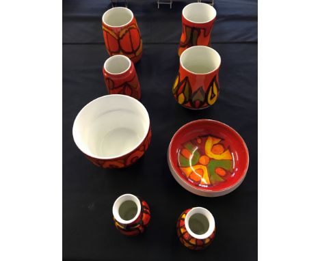 A group of red and orange Poole pottery to include vases and bowls. Eight pieces in total.