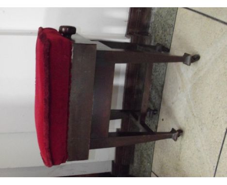 Edwardian piano stool with rise and fall seat, tapering supports on casters with cross stretcher