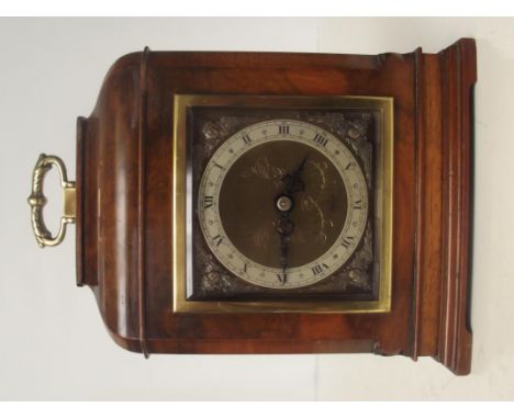An Elliot walnut cased mantel clock, brass face with Roman numerals and stylised cherub spandrels, height 22cm  