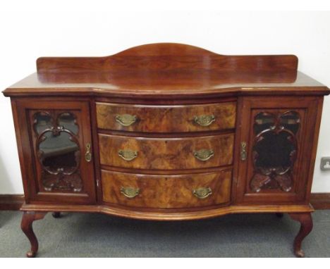 Late Victorian walnut bow fronted sideboard, three central drawers flanked by two glazed cupboards, raised on cabriole legs, 