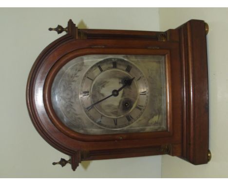 19th century bracket clock striking on a coil, silvered dial with Roman numerals flanked by two columns, brass finials and bu